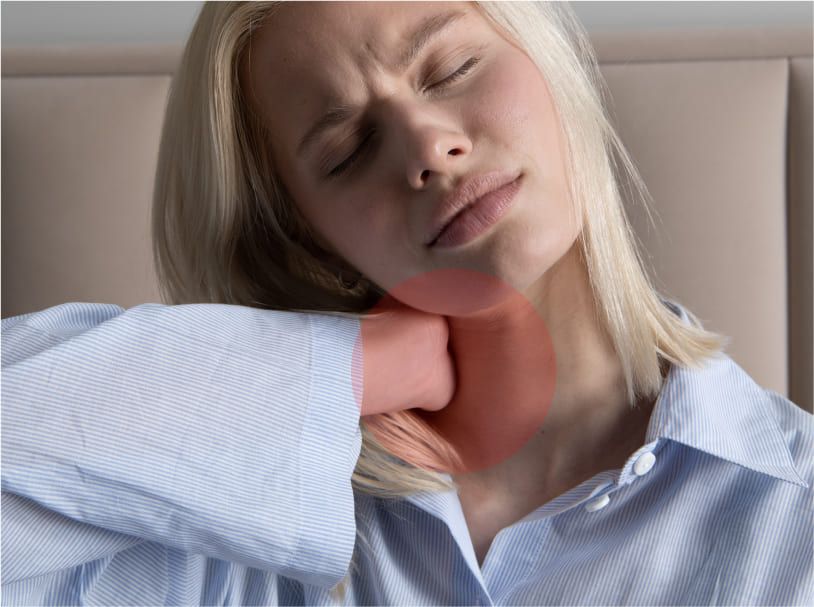 Woman experiencing neck discomfort after a poor night's sleep