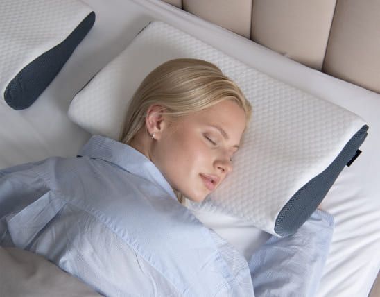 Overhead view of a person sleeping comfortably on the Derila pillow
